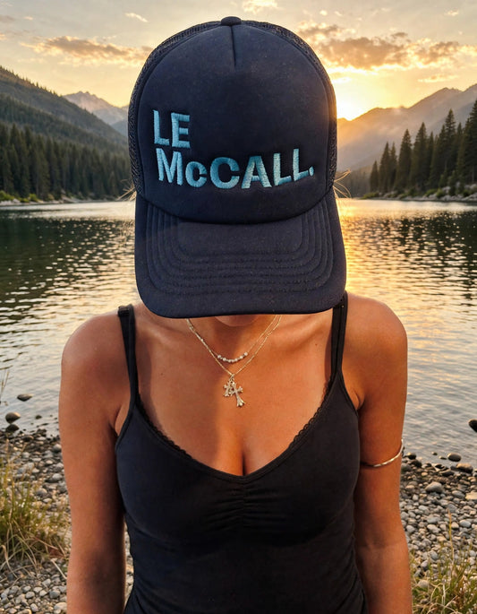 Le McCall trucker hat Navy on the hat model at Payette Lake